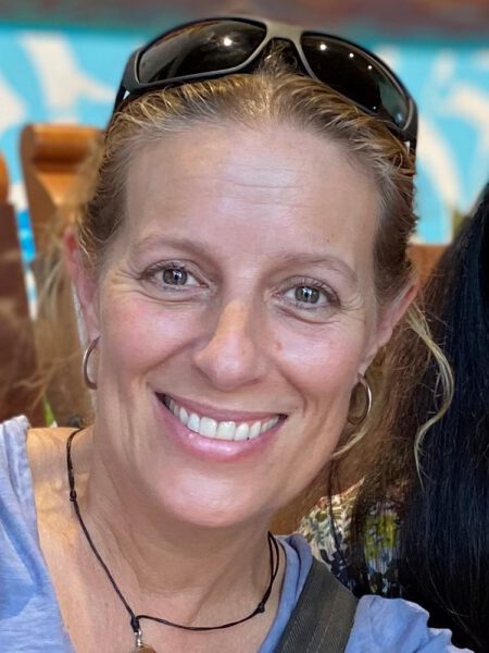 Photo of Sevenstar Academy parent Holly looking at camera and smiling.