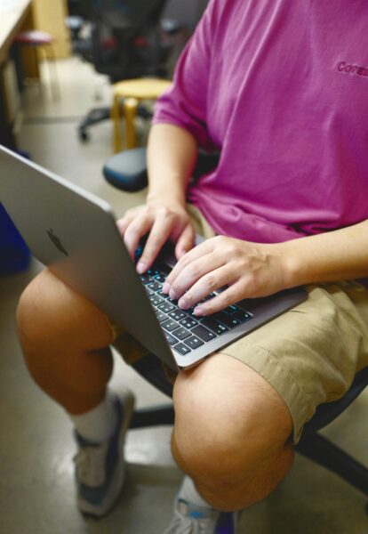 Male student using a laptop.