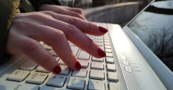 Female hands on laptop